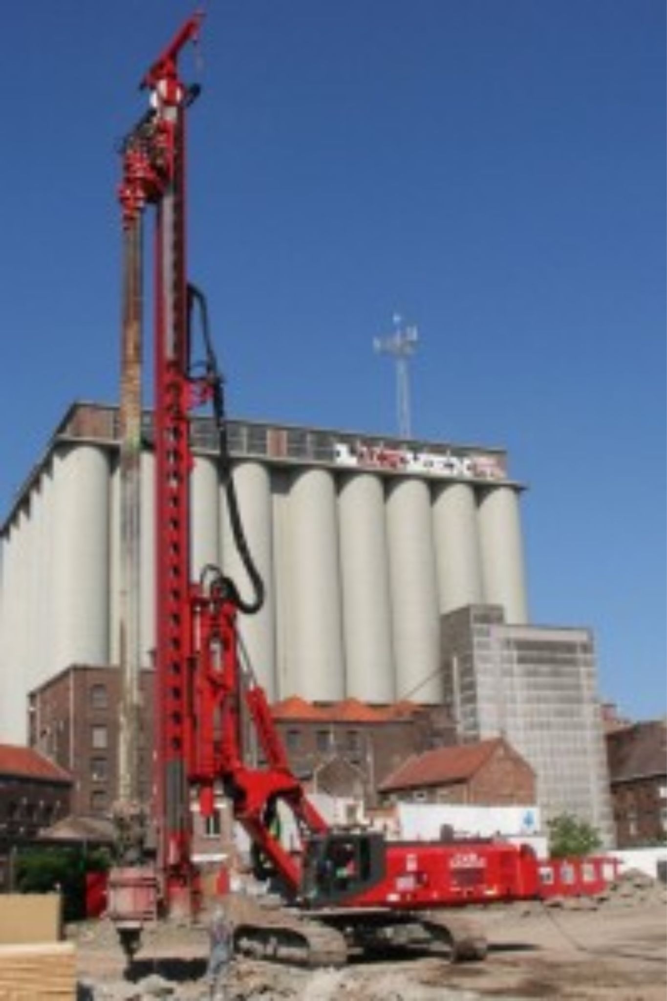 ABI fixed leader mast rig in red finish on a heavy industrial site